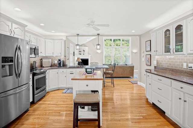 2 Christin Way, Woburn, MA 01801 - kitchen with appliances with stainless steel finishes, backsplash, a ceiling fan, white cabinetry, and light wood-type flooring