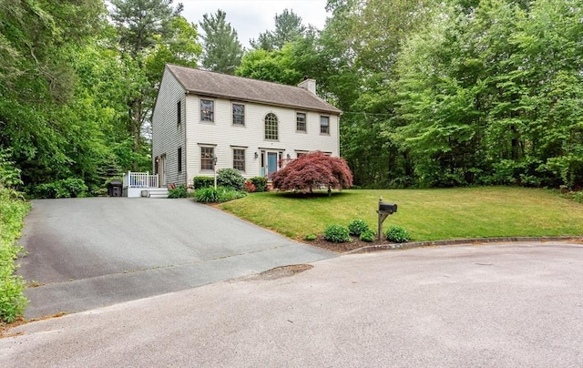 16 Austin Ln, Acushnet, MA 02743 - colonial house with a chimney, a front yard, and driveway