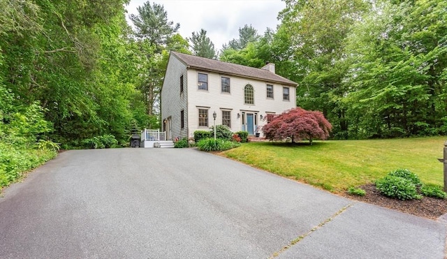 16 Austin Ln, Acushnet, MA 02743 - colonial house with a chimney, a front lawn, and view of scattered trees