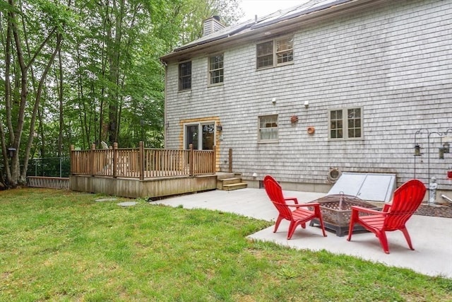 16 Austin Ln, Acushnet, MA 02743 - rear view of house featuring a patio area, a wooden deck, a chimney, and a yard