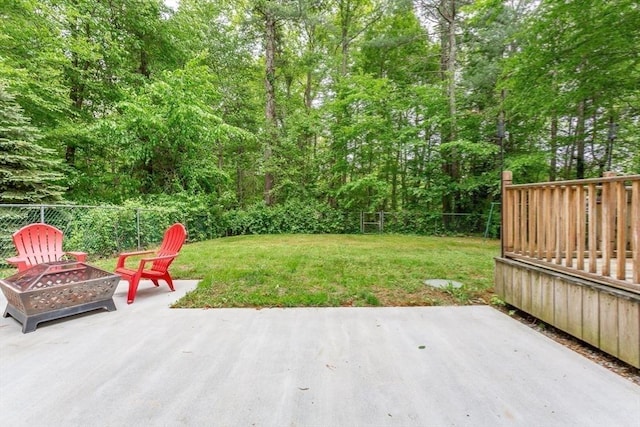 16 Austin Ln, Acushnet, MA 02743 - wooden terrace with a fire pit, a patio area, and a view of trees