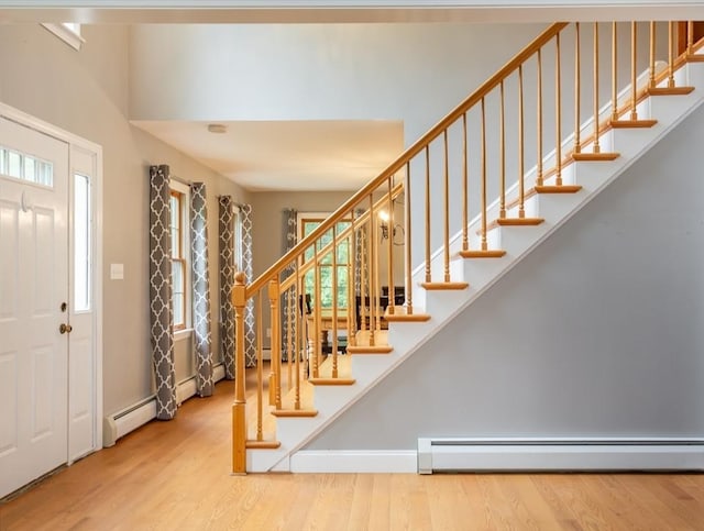 16 Austin Ln, Acushnet, MA 02743 - foyer featuring a baseboard radiator, stairs, and wood finished floors