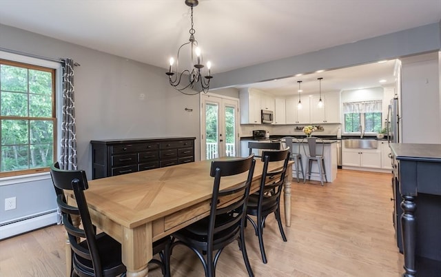 16 Austin Ln, Acushnet, MA 02743 - dining area with french doors, healthy amount of natural light, light wood finished floors, and a chandelier