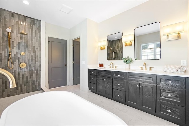 bathroom featuring vanity and independent shower and bath