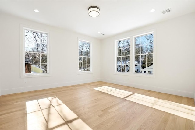 unfurnished room with light hardwood / wood-style flooring