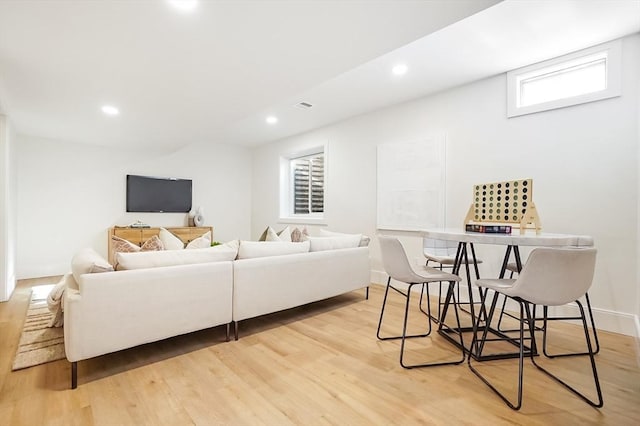 living room with a healthy amount of sunlight and light hardwood / wood-style floors