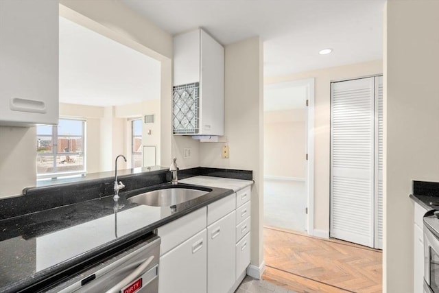 931 Massachusetts Ave Unit 1003, Cambridge, MA 02139 - kitchen with stainless steel dishwasher, white cabinets, dark stone counters, and recessed lighting