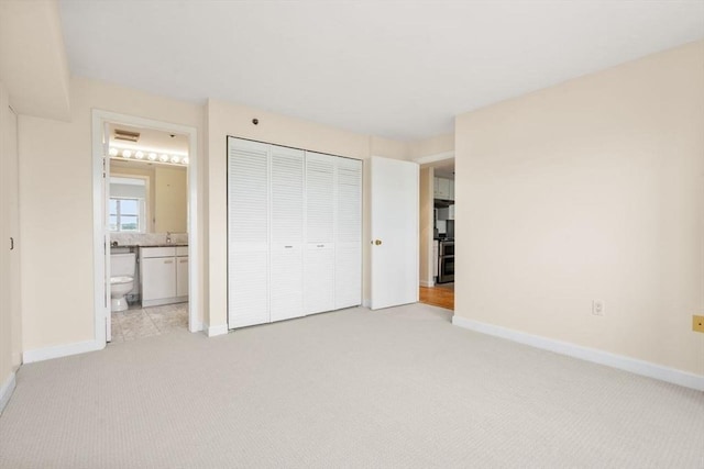 931 Massachusetts Ave Unit 1003, Cambridge, MA 02139 - unfurnished bedroom featuring carpet flooring, a closet, and ensuite bathroom