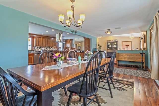 dining area with an inviting chandelier, recessed lighting, wood-type flooring, and visible vents