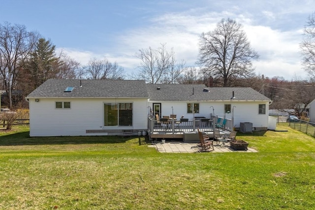 rear view of house featuring a wooden deck, fence, a patio, a lawn, and an outdoor fire pit