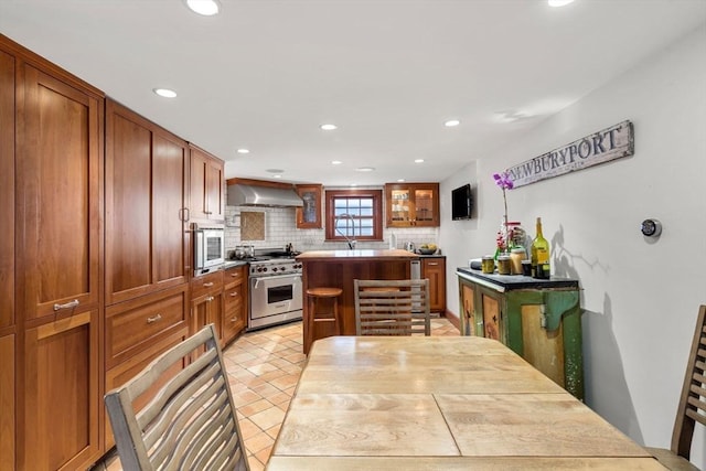 164 Water St Unit 164, Newburyport, MA 01950 - kitchen with stainless steel range, extractor fan, decorative backsplash, a center island, and recessed lighting