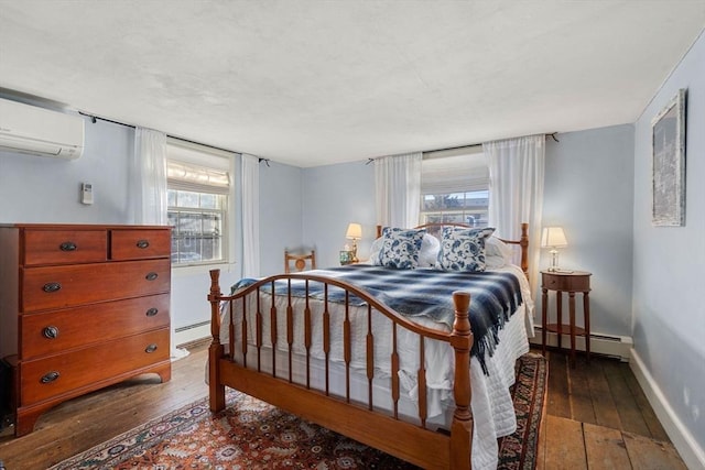 164 Water St Unit 164, Newburyport, MA 01950 - bedroom with a baseboard heating unit, a wall mounted air conditioner, hardwood / wood-style floors, and multiple windows