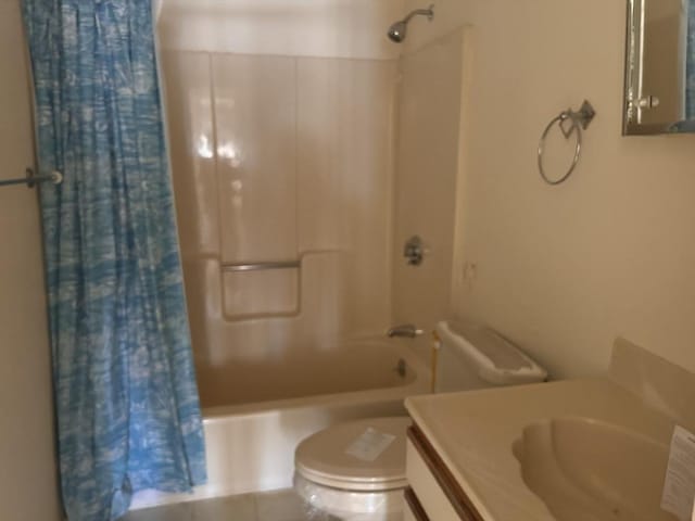 full bathroom featuring shower / tub combo, vanity, and toilet