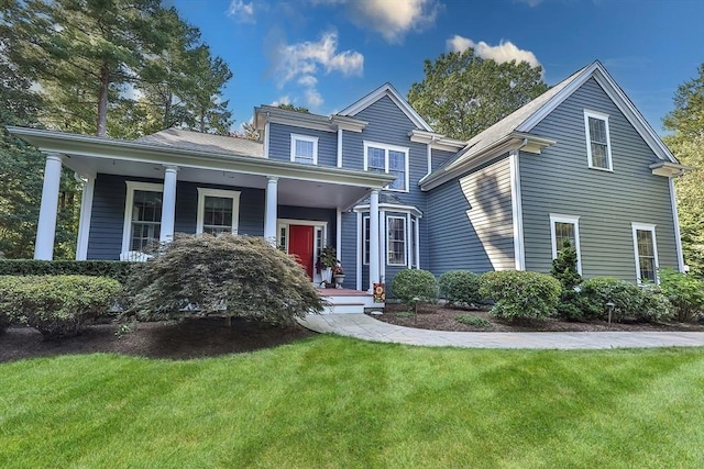 view of front of house with a front yard and a porch