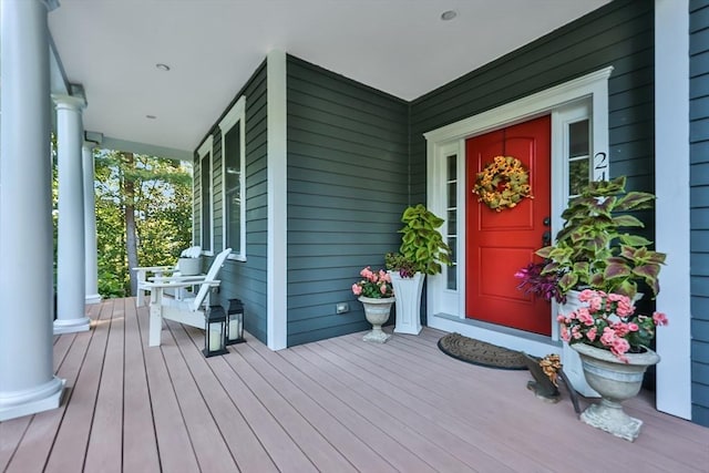 view of exterior entry featuring covered porch