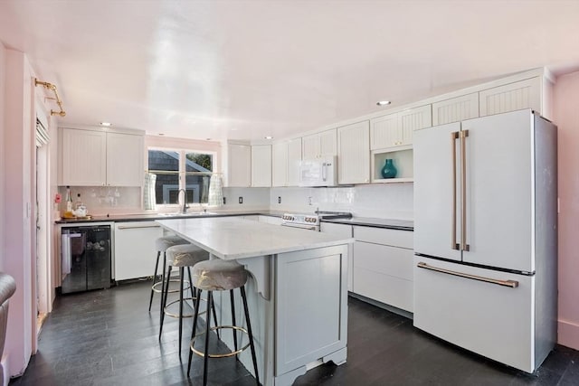 3 Gold Star Dr, Nantucket, MA 02554 - kitchen with dark wood-style floors, white appliances, white cabinetry, and tasteful backsplash