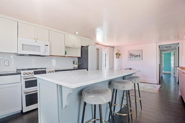 3 Gold Star Dr, Nantucket, MA 02554 - kitchen featuring decorative backsplash, a breakfast bar, white appliances, and a kitchen island