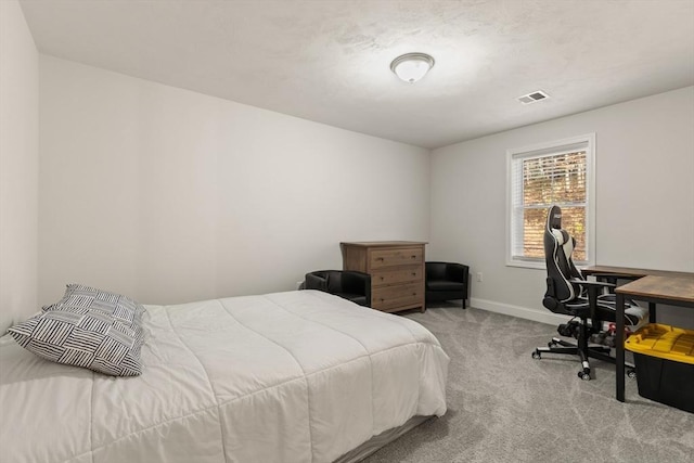 carpeted bedroom with visible vents and baseboards