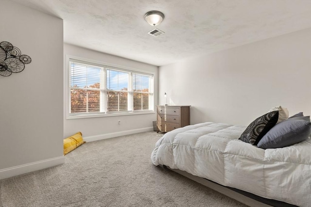 bedroom with baseboards, carpet flooring, and visible vents