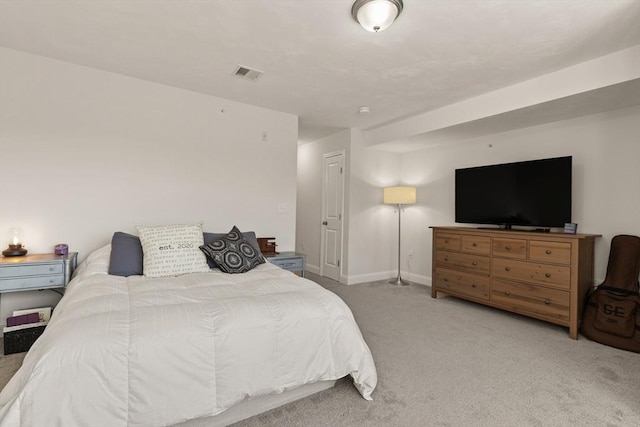 carpeted bedroom featuring visible vents and baseboards