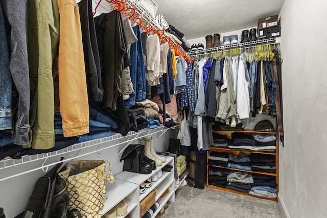 walk in closet with carpet