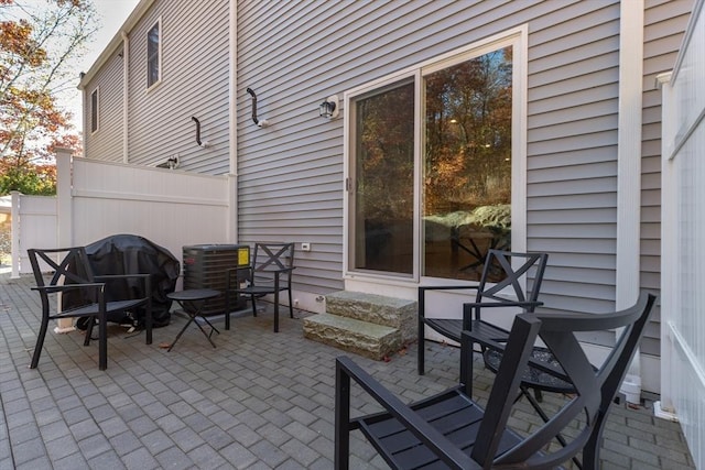 view of patio / terrace with entry steps, central AC unit, and grilling area