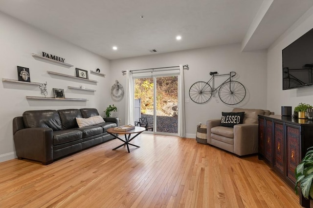 living area with recessed lighting, baseboards, light wood finished floors, and visible vents