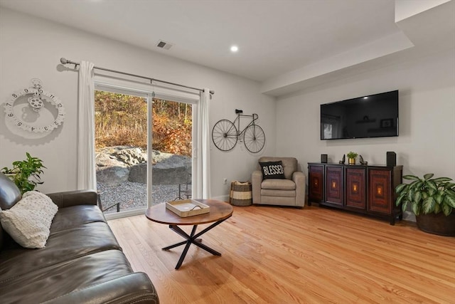 living room with recessed lighting, visible vents, and light wood-style flooring