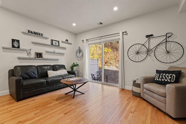 living room featuring visible vents, recessed lighting, baseboards, and wood-type flooring