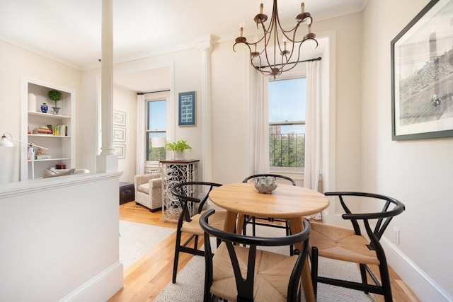 84 Commonwealth Ave Unit 4, Boston, MA 02116 - dining room with light wood-style floors, a chandelier, built in shelves, crown molding, and baseboards