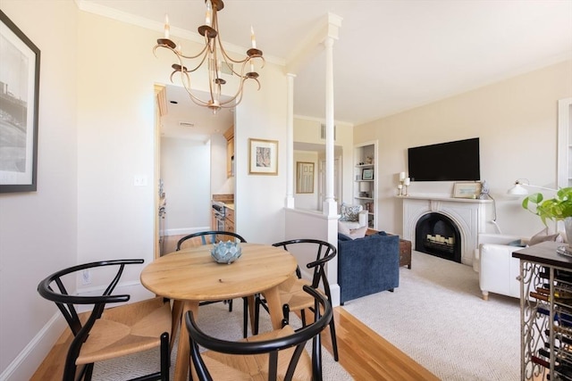 84 Commonwealth Ave Unit 4, Boston, MA 02116 - dining room featuring a fireplace, ornamental molding, baseboards, wood finished floors, and a chandelier