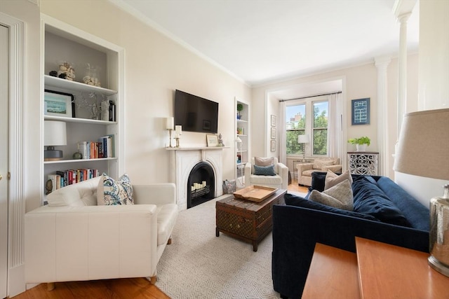 84 Commonwealth Ave Unit 4, Boston, MA 02116 - living room featuring built in shelves, a fireplace, ornamental molding, wood finished floors, and ornate columns