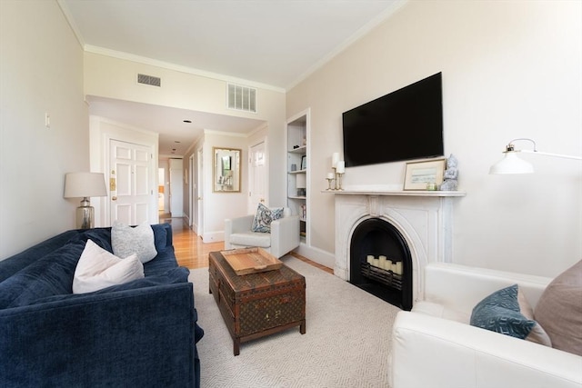84 Commonwealth Ave Unit 4, Boston, MA 02116 - living room featuring crown molding, built in features, a fireplace with flush hearth, baseboards, and wood finished floors