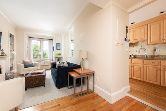 84 Commonwealth Ave Unit 4, Boston, MA 02116 - living area featuring crown molding, light wood finished floors, baseboards, and bar with sink