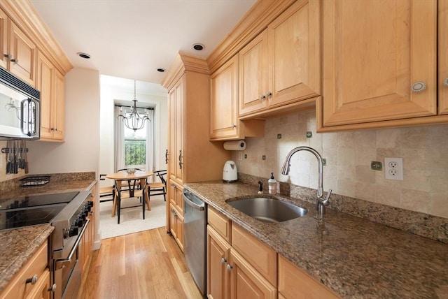 84 Commonwealth Ave Unit 4, Boston, MA 02116 - kitchen featuring stainless steel appliances, a sink, light wood-type flooring, a chandelier, and tasteful backsplash