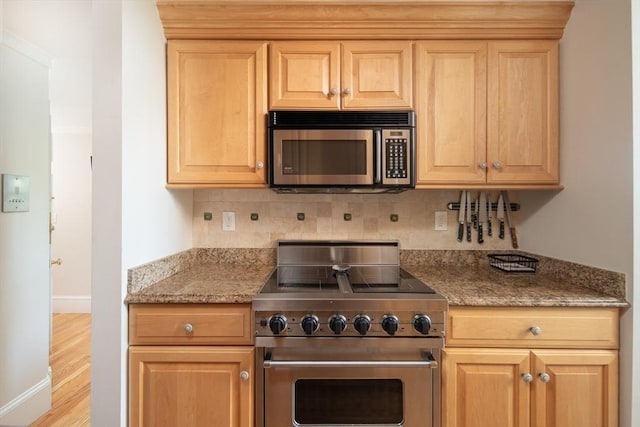 84 Commonwealth Ave Unit 4, Boston, MA 02116 - kitchen with appliances with stainless steel finishes, tasteful backsplash, light wood-type flooring, baseboards, and light stone countertops