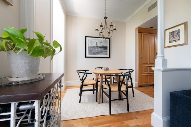 84 Commonwealth Ave Unit 4, Boston, MA 02116 - dining room featuring light wood-style flooring, crown molding, a chandelier, baseboards, and decorative columns