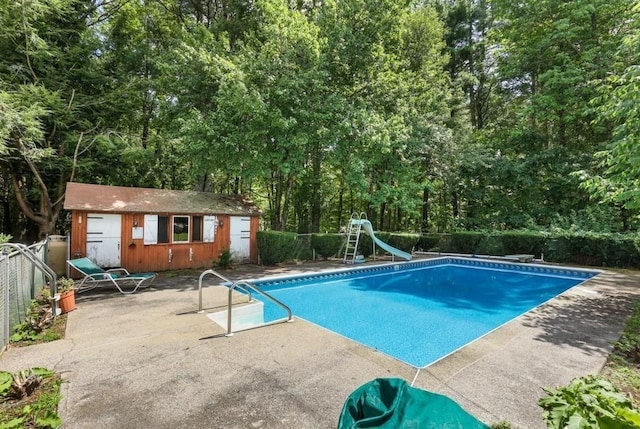 17 Crowningshield Dr, Paxton, MA 01612 - view of pool with a water slide, a patio, an outbuilding, a diving board, and a storage structure