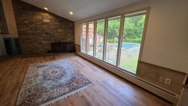17 Crowningshield Dr, Paxton, MA 01612 - unfurnished living room with vaulted ceiling, wood finished floors, a baseboard heating unit, and recessed lighting