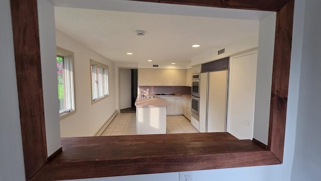 17 Crowningshield Dr, Paxton, MA 01612 - kitchen with white cabinets, light tile patterned floors, stainless steel double oven, paneled built in refrigerator, and recessed lighting