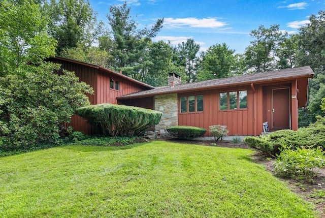 17 Crowningshield Dr, Paxton, MA 01612 - view of side of home with board and batten siding, a lawn, and a chimney