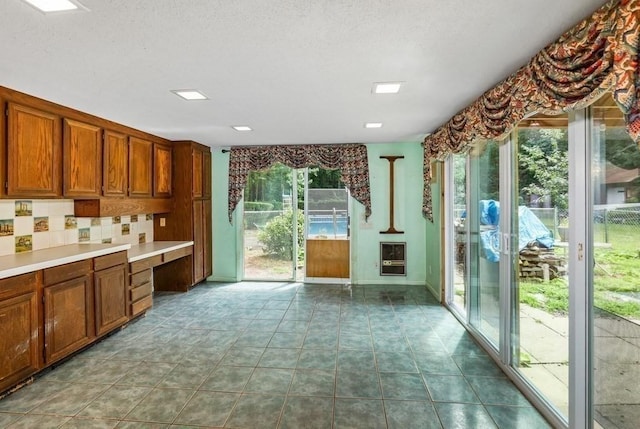 17 Crowningshield Dr, Paxton, MA 01612 - kitchen featuring brown cabinets, heating unit, light countertops, and decorative backsplash