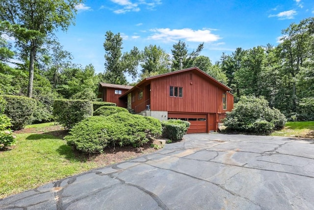 17 Crowningshield Dr, Paxton, MA 01612 - view of side of home featuring asphalt driveway and an attached garage