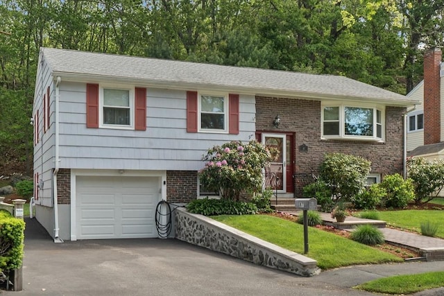 87 Lockwood Rd, Lynn, MA 01904 - split foyer home with driveway, a garage, and brick siding