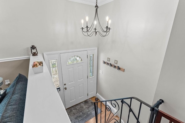 87 Lockwood Rd, Lynn, MA 01904 - foyer entrance featuring a chandelier, baseboards, a high ceiling, wood finished floors, and crown molding