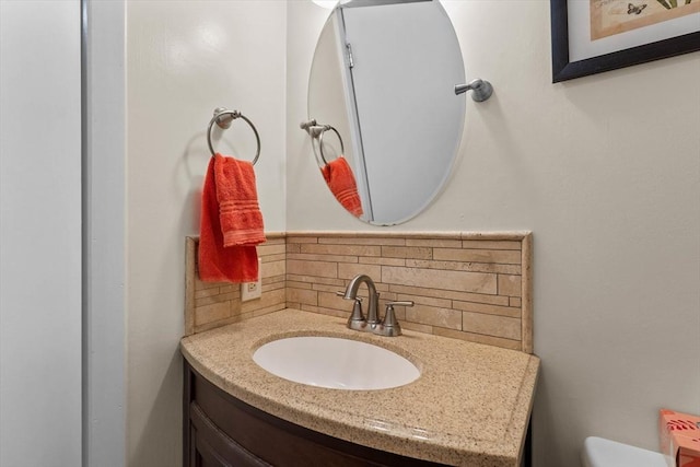 87 Lockwood Rd, Lynn, MA 01904 - half bathroom featuring decorative backsplash, vanity, and toilet