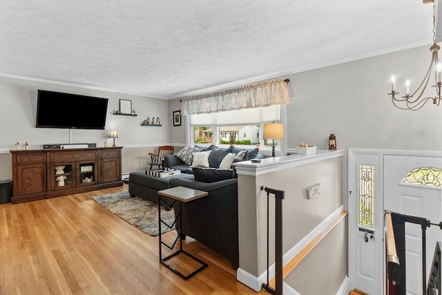 87 Lockwood Rd, Lynn, MA 01904 - living room featuring light wood-style floors, a chandelier, a textured ceiling, and crown molding