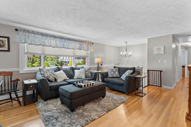 87 Lockwood Rd, Lynn, MA 01904 - living area with light wood finished floors, baseboard heating, a textured ceiling, and crown molding