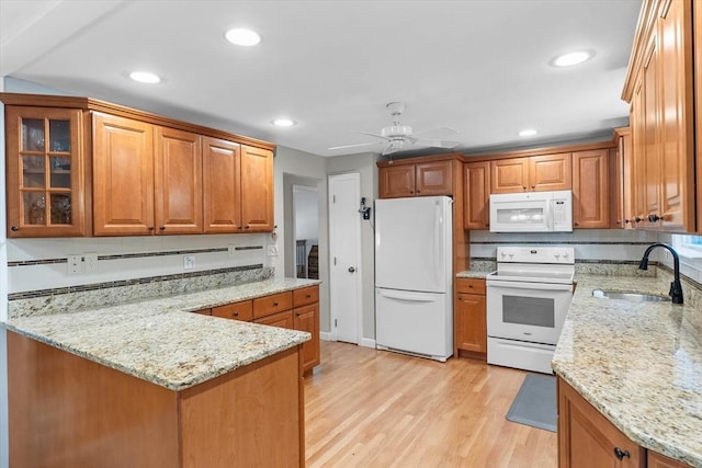 87 Lockwood Rd, Lynn, MA 01904 - kitchen with white appliances, a sink, a peninsula, light stone counters, and light wood finished floors