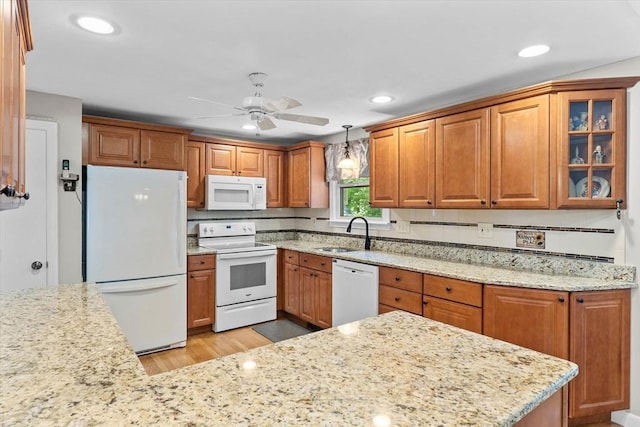 87 Lockwood Rd, Lynn, MA 01904 - kitchen featuring white appliances, a sink, a ceiling fan, light wood finished floors, and light stone countertops